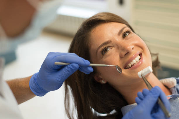 istock Young smiling woman at the dentist 1131678774