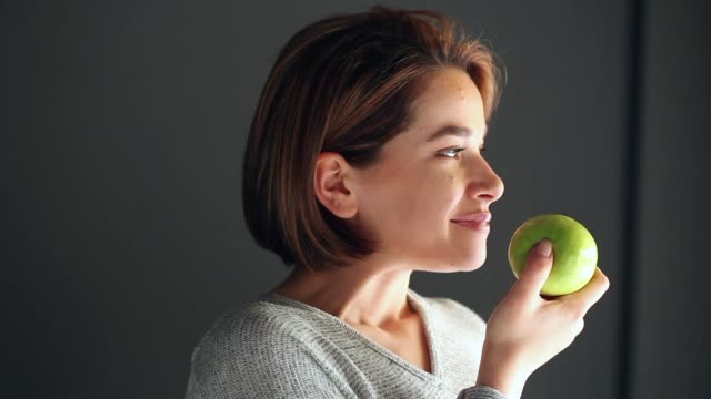 Young Woman Eating Apple