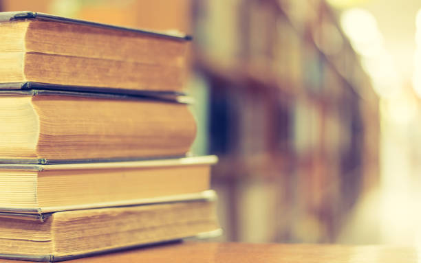 istock Book stack in library study room with bookshelf for business and education background, class learning and back to school concept 1131684772