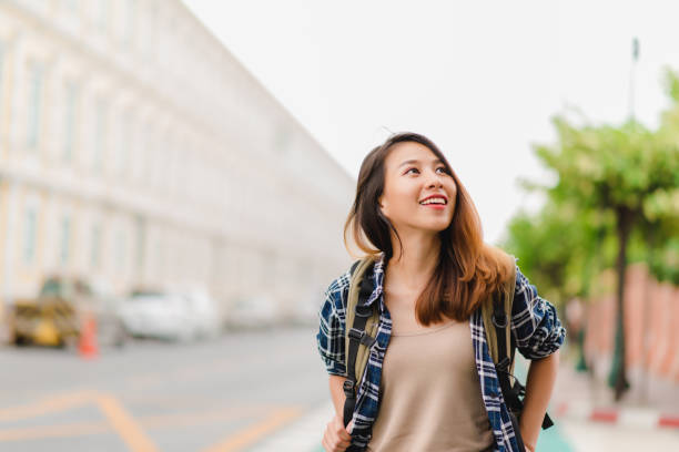 旅行バックパッカー アジア女性は、タイのバンコクに旅行します。幸せな若い女性を過ごす休日の素晴らしいランドマークで旅行と伝統的な都市に彼女の旅をお楽しみください。 - teenager exploration behavior casual ストックフォトと画像