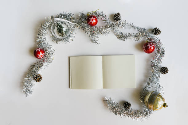 istock Christmas concept with empty blank book with Christmas decorations on white background. 1131691887