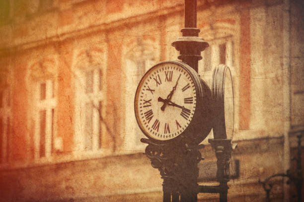 Street clock on a pole. Made in vintage style. Poland. Image in old color style