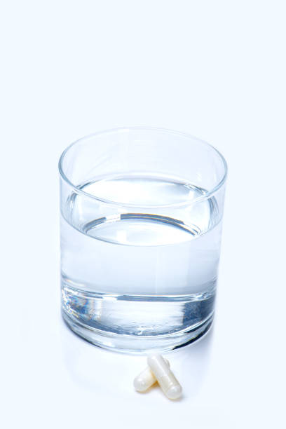 Glass of Water with Capsule stock photo