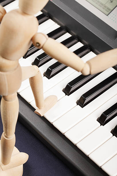 istock Wooden doll stepping on piano 113169485