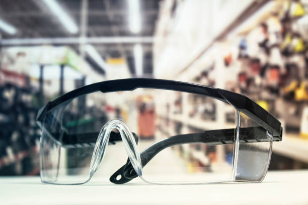 istock Plastic safety goggles, on the table and background of the hardware store with tools. 1131694883