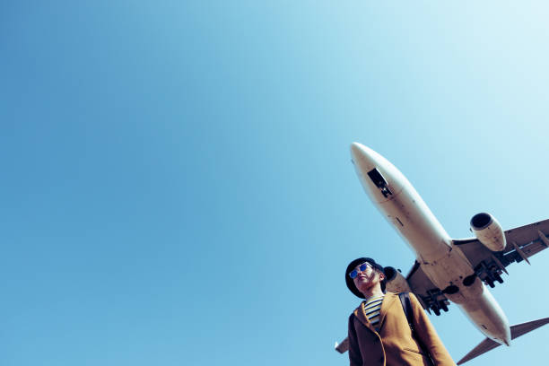 istock Asian woman and airplane 1131696066