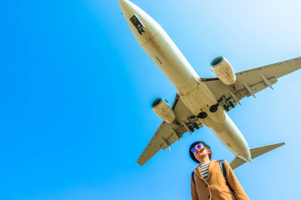 istock Asian woman and airplane 1131696067