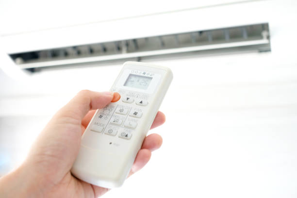 istock Man's hand using remote control open The air conditioner is cooled to 25 degrees Celsius in his bedroom. Health concepts and energy savings 1131698625