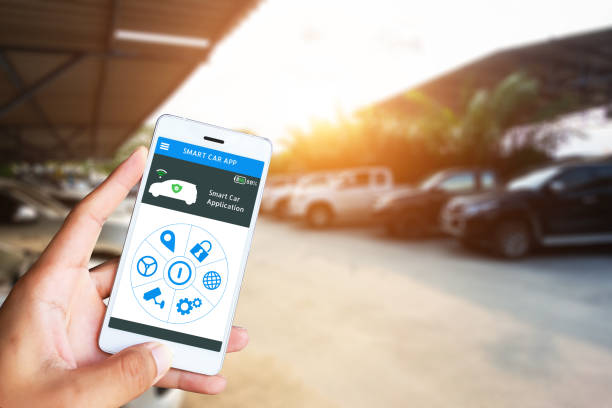 istock Hand holding smart phone and application dashboard with blur car parking background. 1131702997
