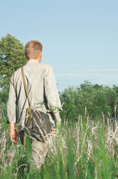 istock soldier is on the field among the tall grass 1131711399