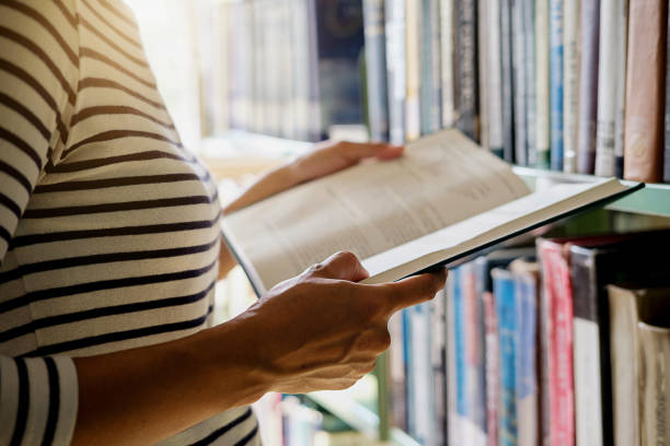 istock Asian woman reading book in library. reading concept 1131715161
