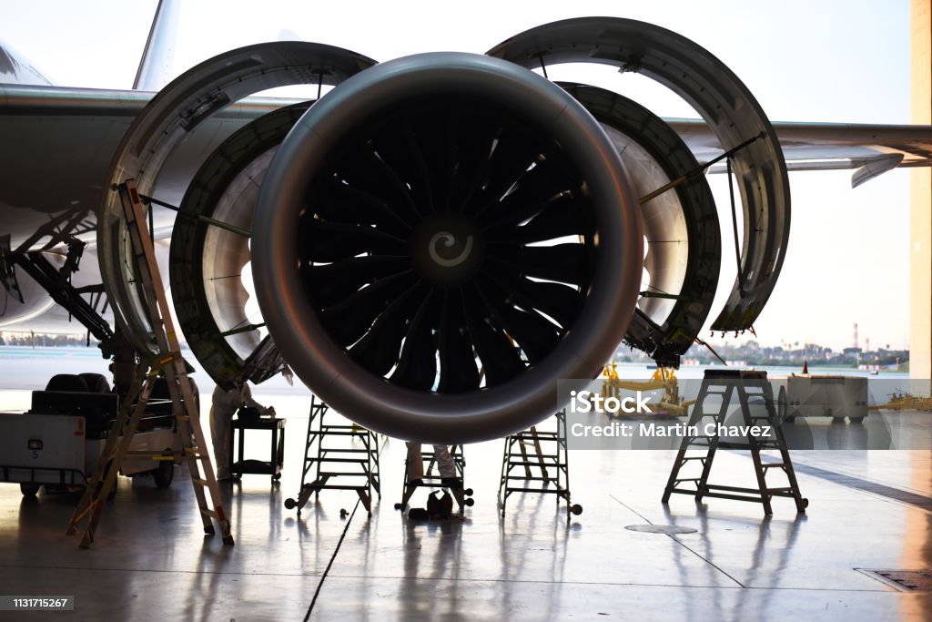 Jet engine with fan cowls and thrust reverser cowls open for maintenance Jet engine with fan cowls and thrust reverser cowls open for maintenance in a hangar during the day. Boeing 787 Stock Photo