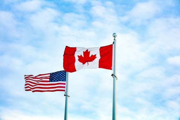 istock Canadian and American flag together 1131716095