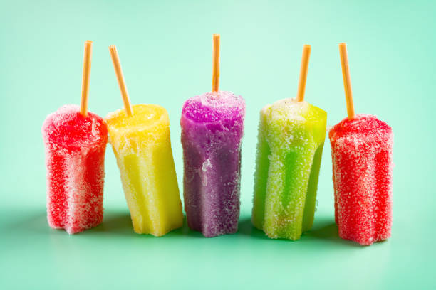 istock side view multi-color popsicles line up on green background 1131720889