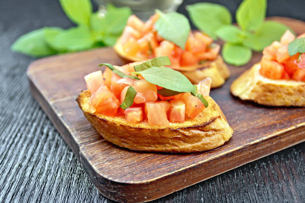 istock Bruschetta with tomato and basil on wooden board 1131724124