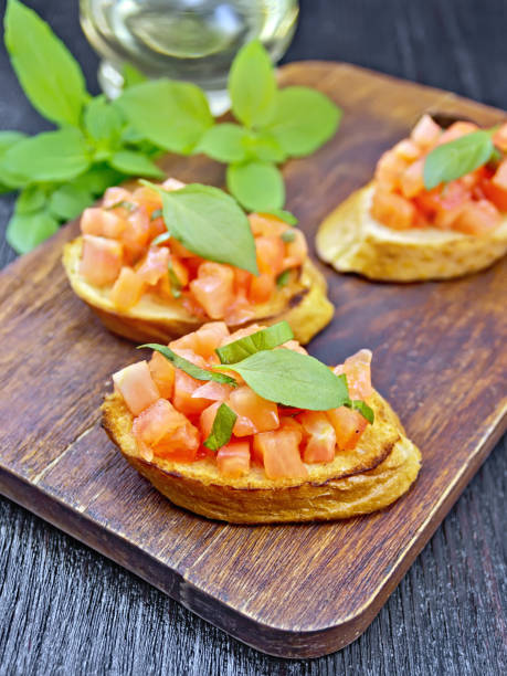 istock Bruschetta with tomato and basil on black board 1131724127
