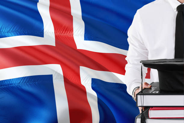 istock Successful student education concept. Holding books and graduation cap over Iceland flag background. 1131724384