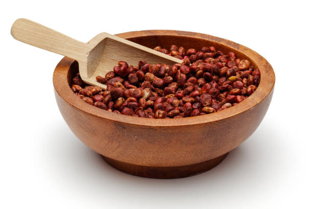 Dried sumac berries with spoon in wooden bowl Dried sumac berries with spoon in wooden bowl isolated on white background sumac stock pictures, royalty-free photos & images