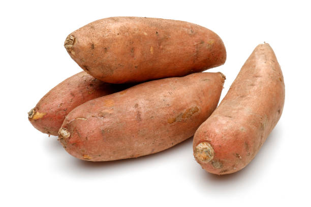 istock Whole sweet potatoes isolated on white 1131726552