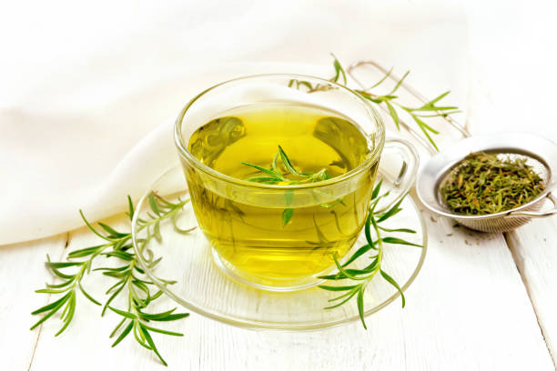 istock Tea of rosemary in cup with napkin on light board 1131728229