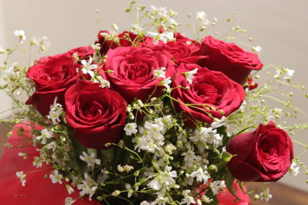 istock bouquet of red roses and black forest cake 1131729330