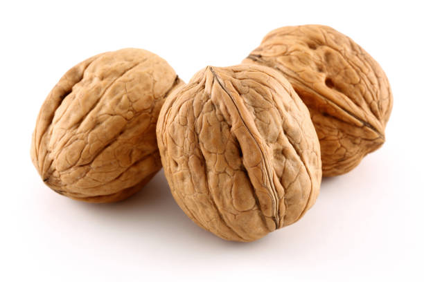 istock Group of whole walnuts isolated on white 1131732233