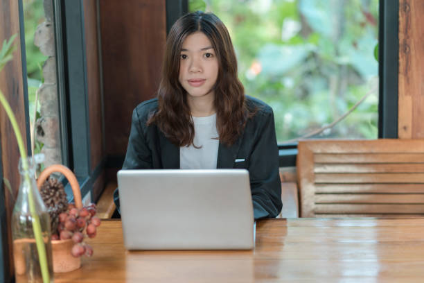 istock woman using laptop and smartphone in cafe 1131732576