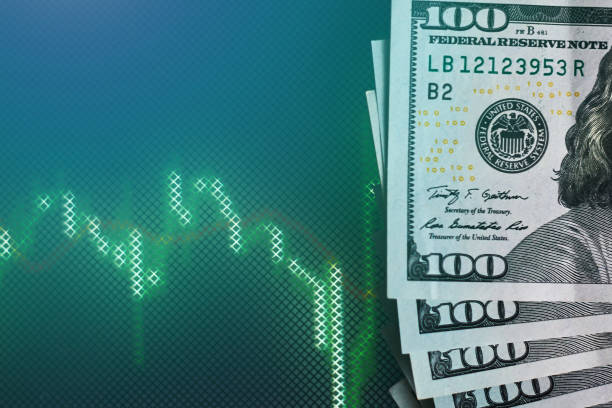 istock US dollar bills on background with dynamics of exchange rates. Trading and financial risk concept 1131736370