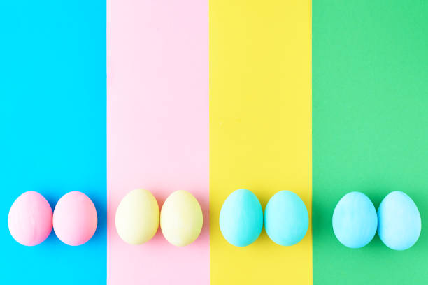 istock Eggs on colored striped background, top view, minimalism concept 1131736412
