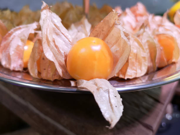 A full, silver tray of fresh, Thai grown, cape gooseberries.
