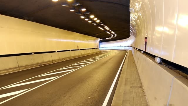 Modern car tunnel with good lighting. Highway road