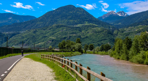 istock bike road along the river etsch. 1131742002