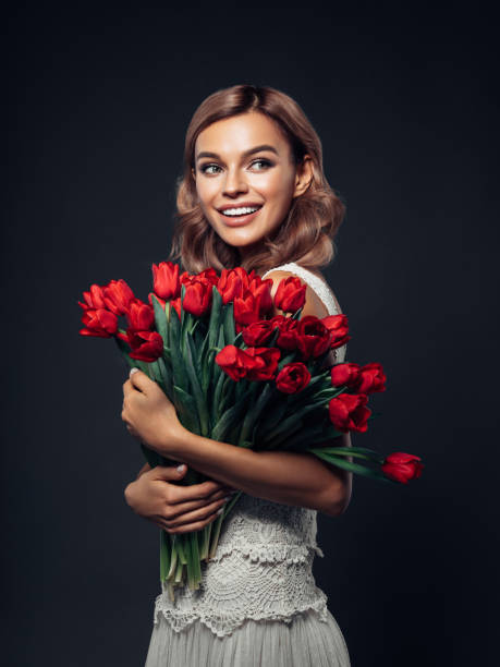istock Beautiful woman with tulips 1131743241