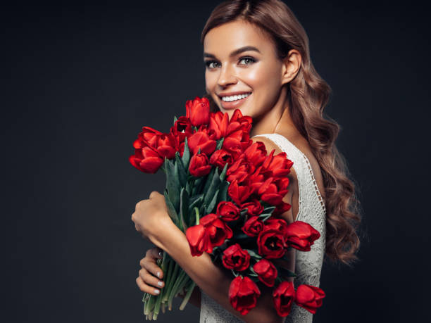 istock Beautiful woman with tulips 1131743328