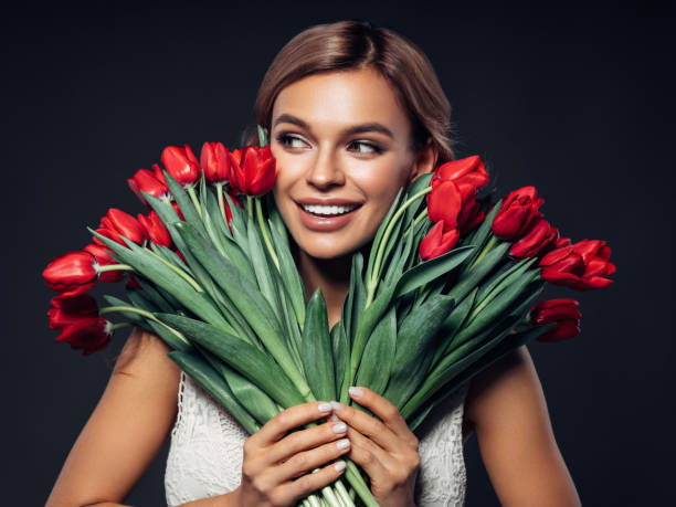 istock Beautiful woman with tulips 1131743405