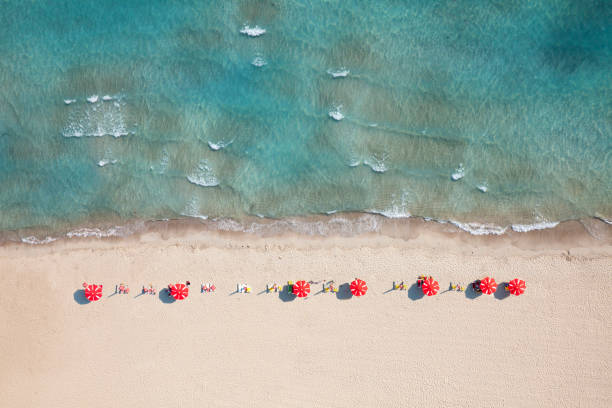 istock peaceful beach with red umbrellas 1131744070