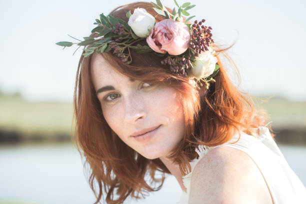 beautiful woman outdoors with a wreath on her head stock photo