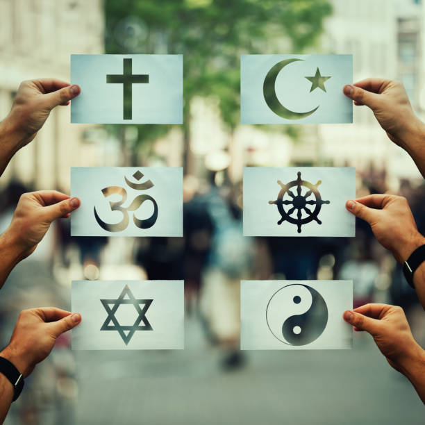 Religion conflicts global issue Religion conflicts as global issue concept. Human hands holding different paper with faith symbols over crowded street scene. Relations between different people doctrines and beliefs, social problem. religious symbol stock pictures, royalty-free photos & images