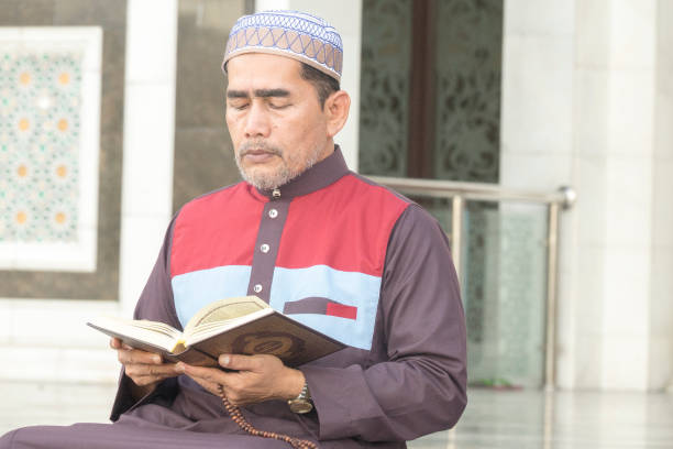 istock Mature Man Reading Koran While Sitting At Mosque 1131750230
