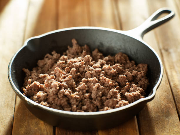 istock freshly browned ground beef in iron skillet on wooden table top 1131750968