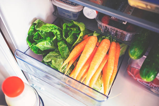 Fresh vegetables for storage in the fridge in a plastic box stock photo