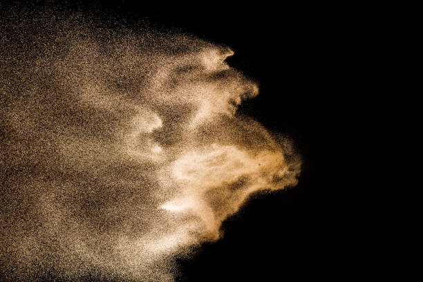 istock Golden sand explosion isolated on black background. Abstract sand cloud. Golden colored sand splash against dark background. Yellow sand fly wave in the air. 1131754497