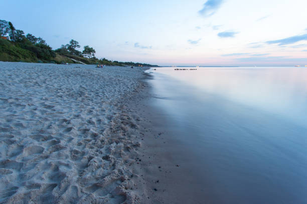 istock smooth sea surface and coast in blue twilight on long exposure 1131758450