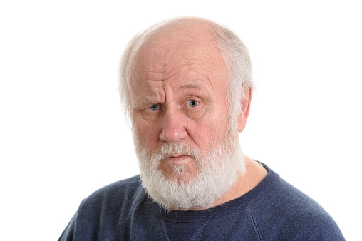 dissatisfied and displeased old bald man isolated portrait isolated on white