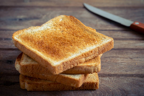 istock Stack of sliced toast on old wooden table 1131760521