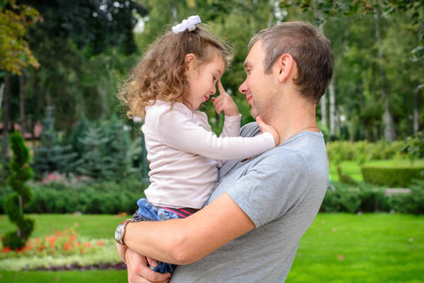 istock The daughter thinks in the hands of his father 1131760623