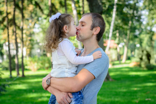 istock Father and daughter kiss each other 1131760630