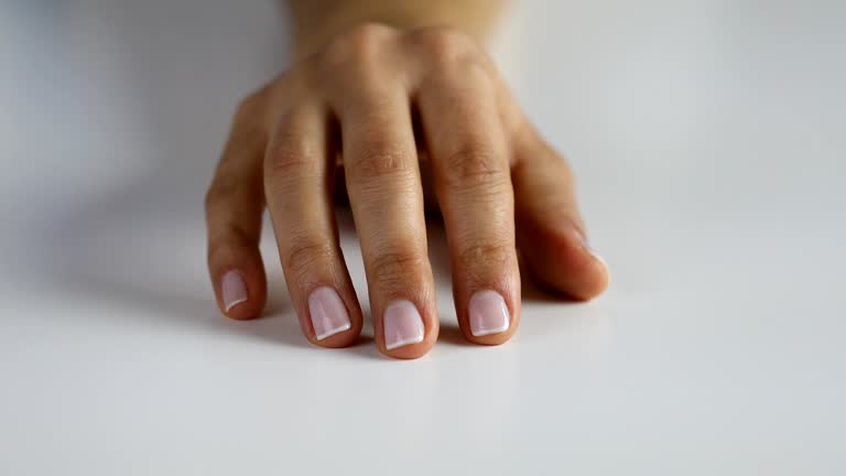 Woman tapping her fingers on the table waiting or thinking something