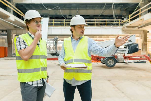istock Male building workers working at construction site. Building, development, teamwork and people concept 1131769583