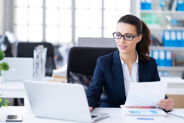 istock Successful young woman in modern office working on laptop 1131773151